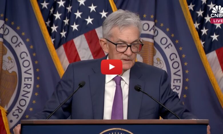 YouTube screenshot of Federal Reserve Chair Jerome Powell speaking at a live press conference with U.S. flags and Board of Governors seal in the background, streamed by CNBC.