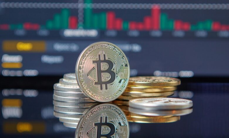 Bitcoin pile in front of stock chart.