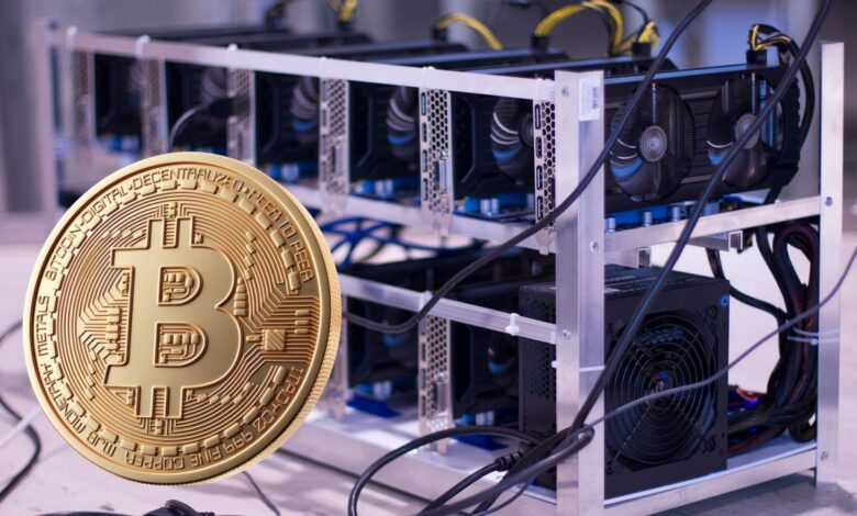 Bitcoin coin in front of Bitcoin mining rig.